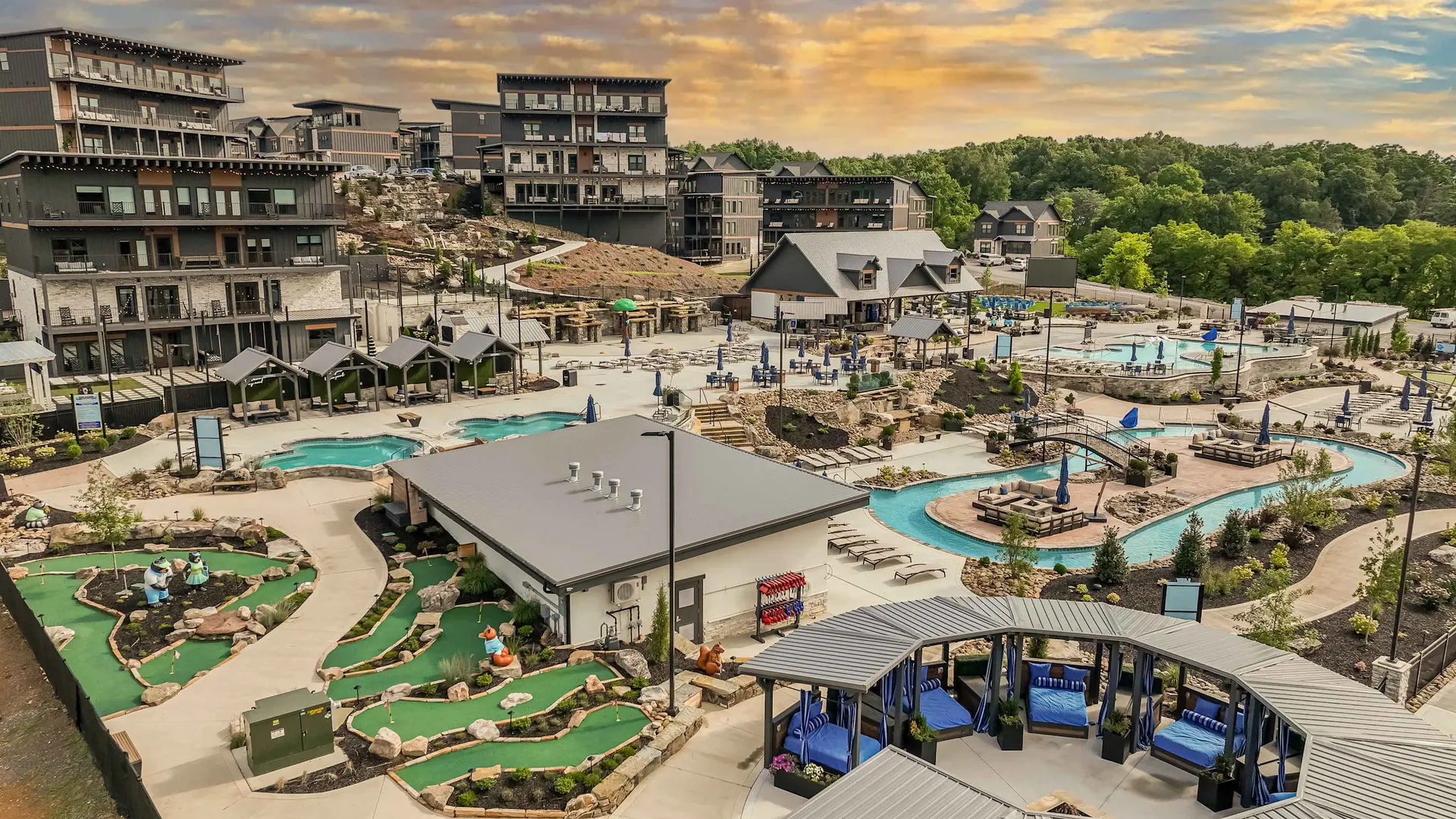 Resort with pools, lazy river, mini golf, and cabins under a cloudy sky.