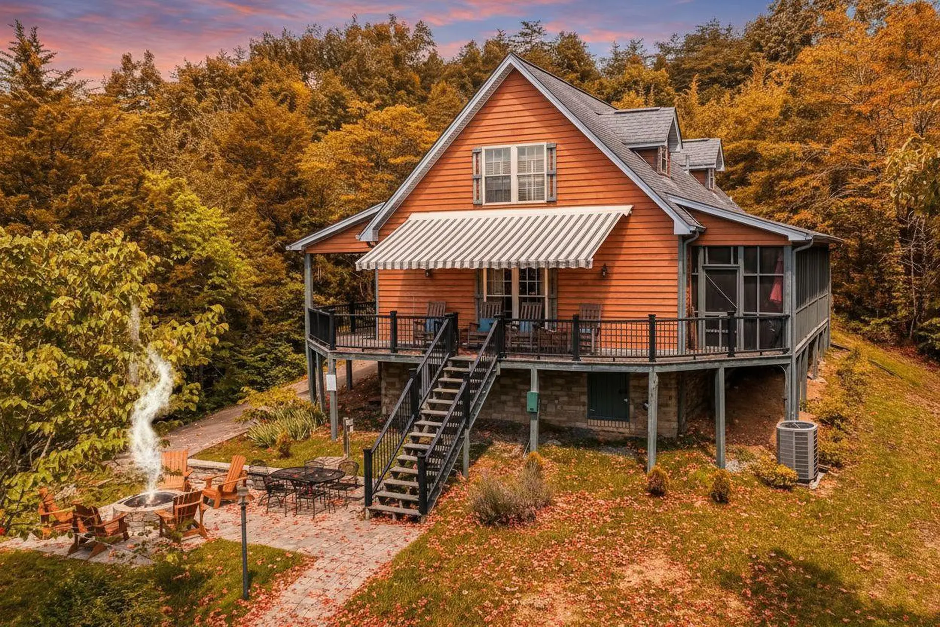 Orange house with a deck and fire pit in the fall.
