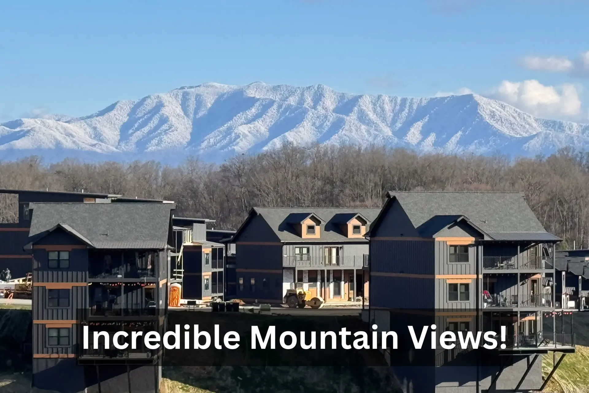 Snow-capped mountains tower over modern buildings, with text overlay reading "Incredible Mountain Vi