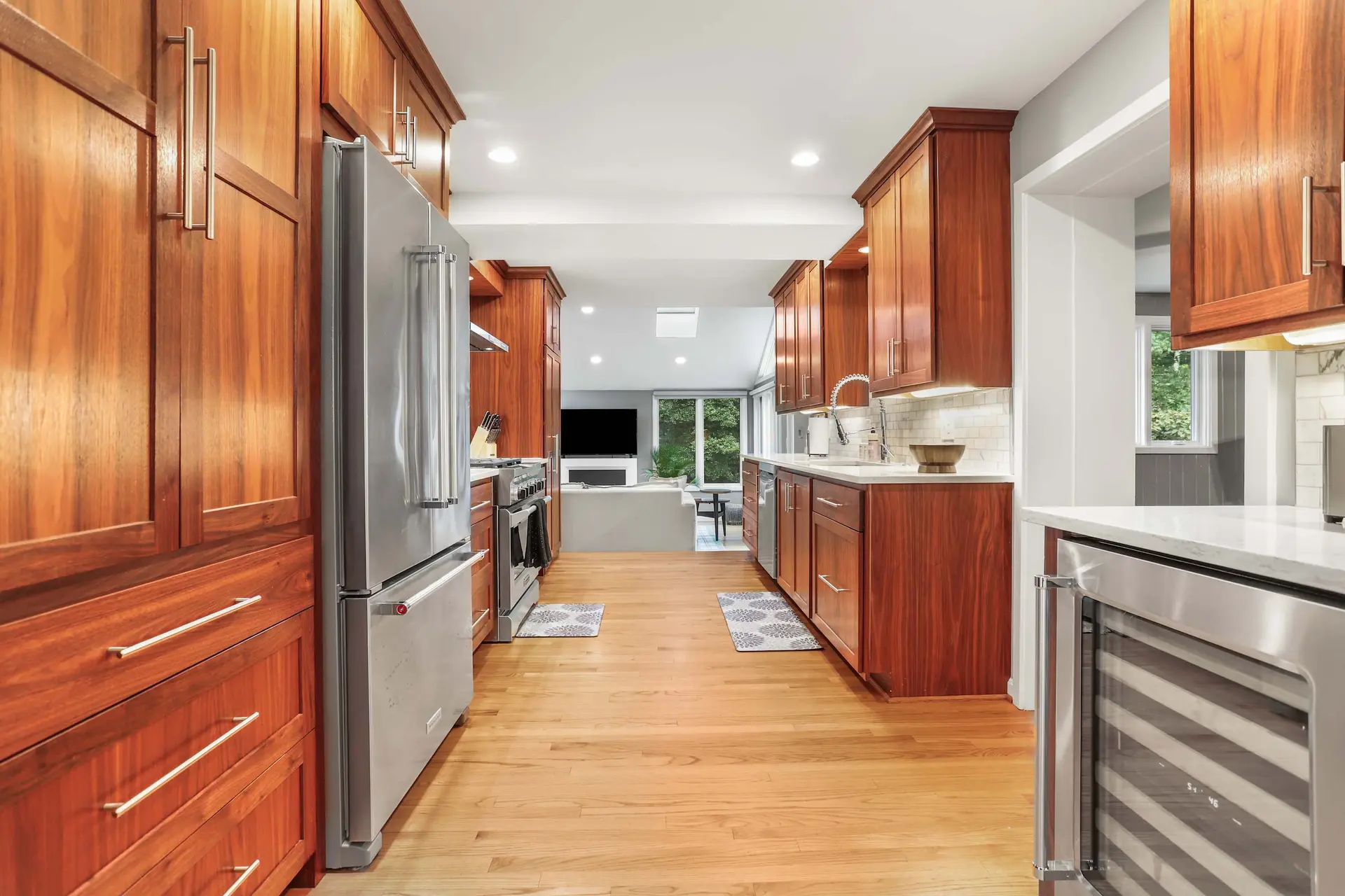 A modern kitchen with wooden cabinets and stainless steel appliances.