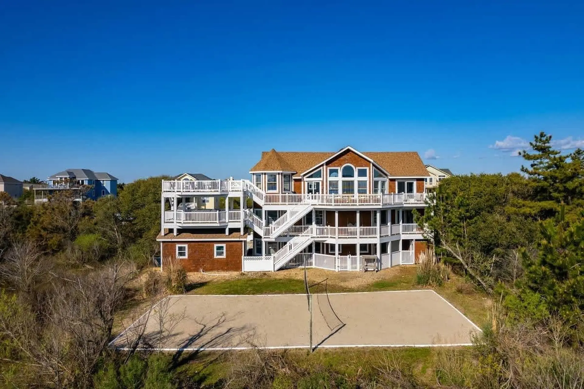 Beach house with a volleyball court in front.