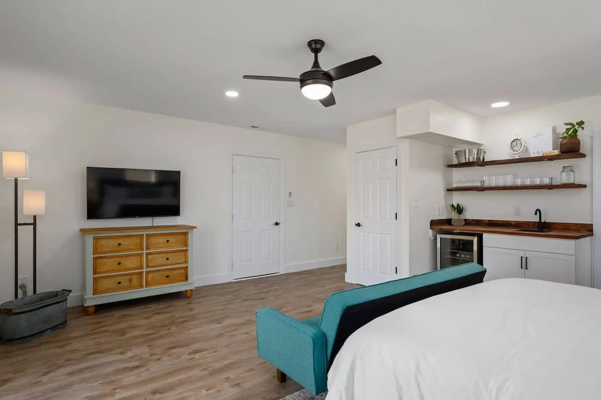 A bedroom and wet bar area in a studio apartment.