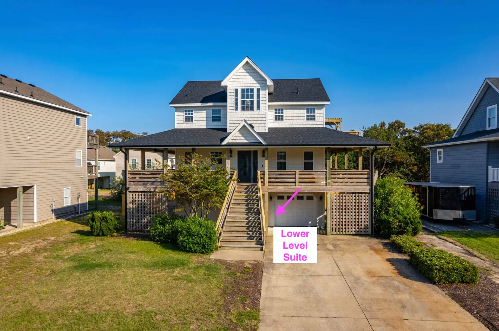 A pink arrow points to the words "Lower Level Suite" overlaid on a garage door.