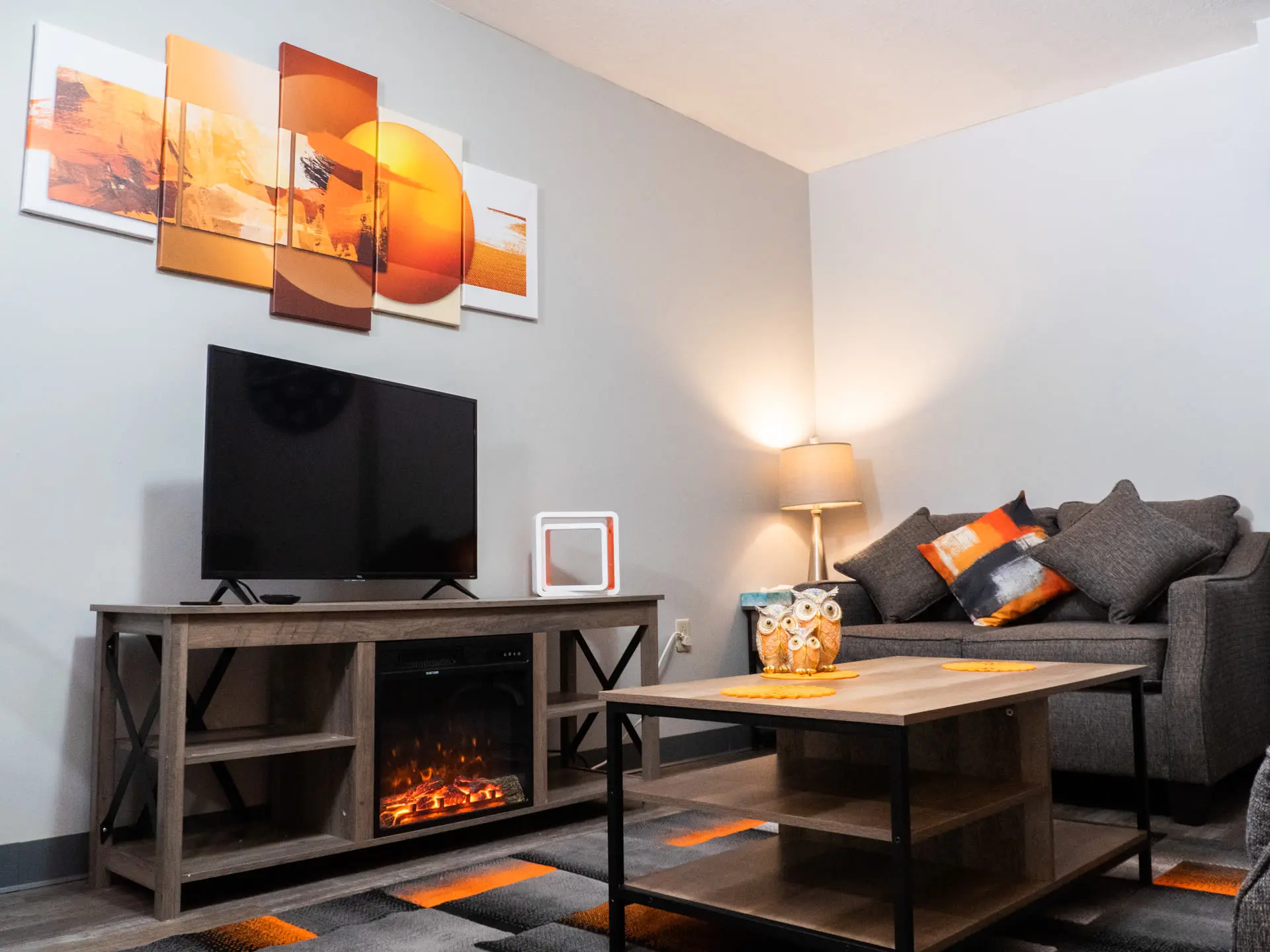 A living room with a fireplace, TV, couch, and coffee table.