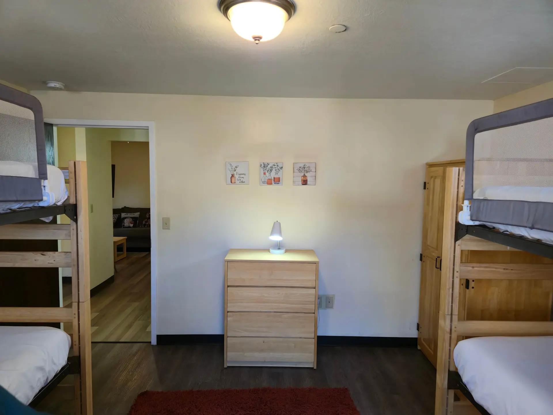 Bunk beds and a dresser in a room.