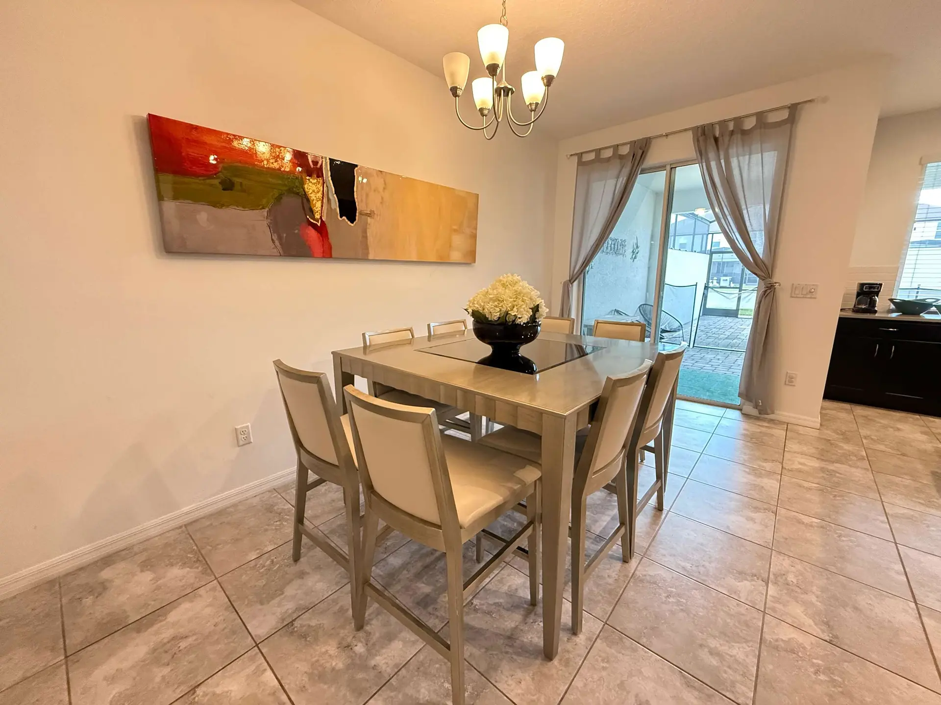 A modern dining room with a light wood table and chairs.