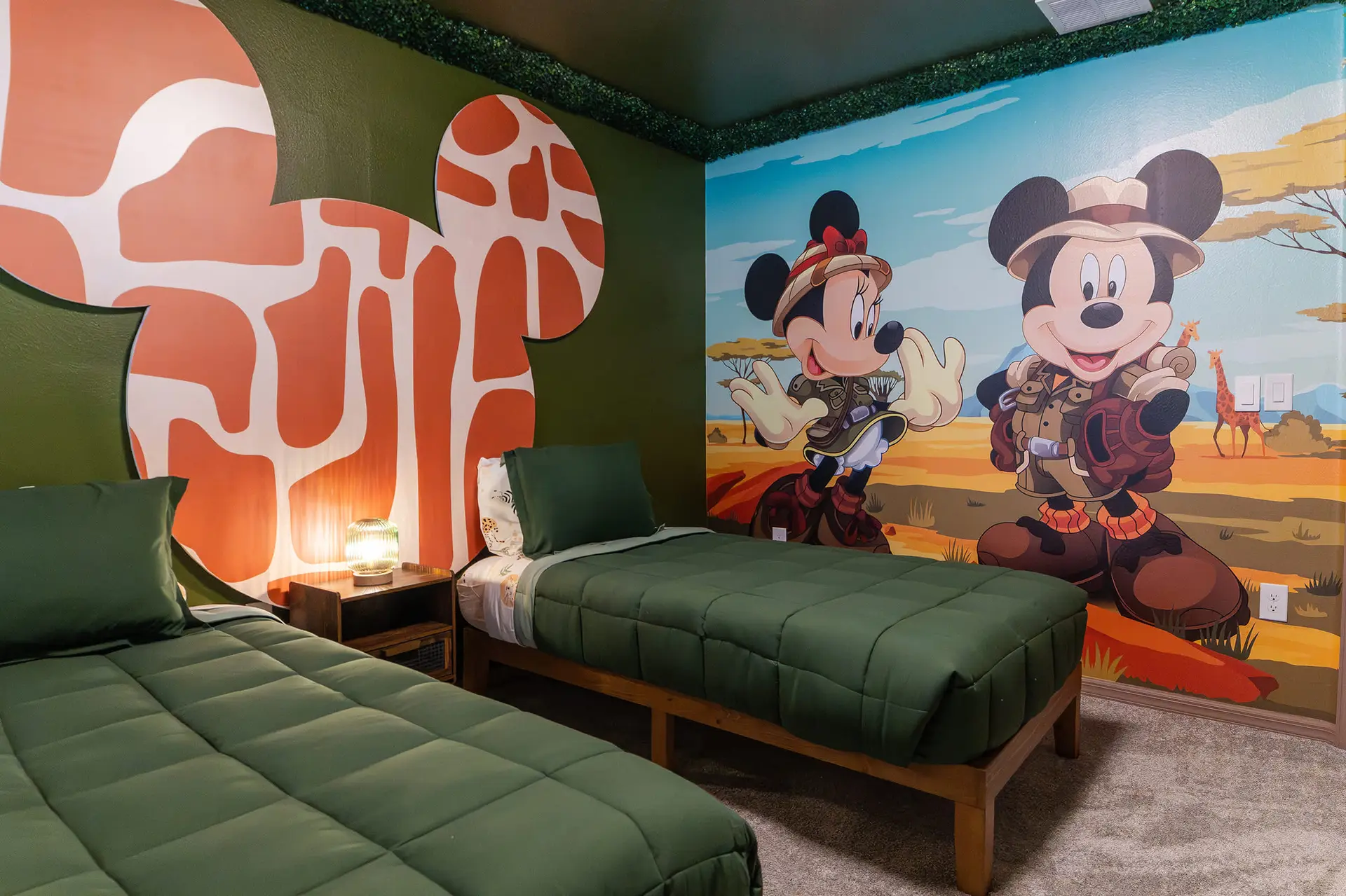 A kids' bedroom with Mickey and Minnie Mouse safari-themed decor.