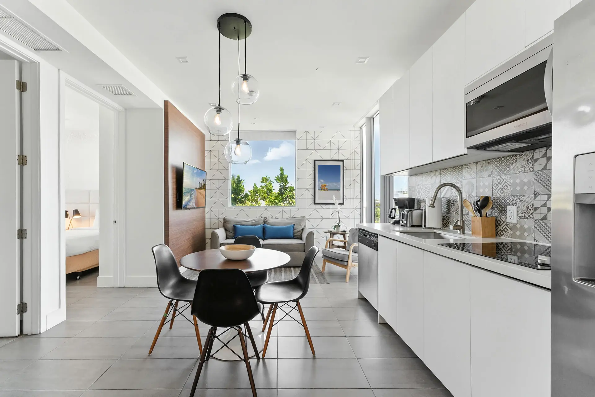 A modern open-plan living area with a kitchen, dining table, and living room.