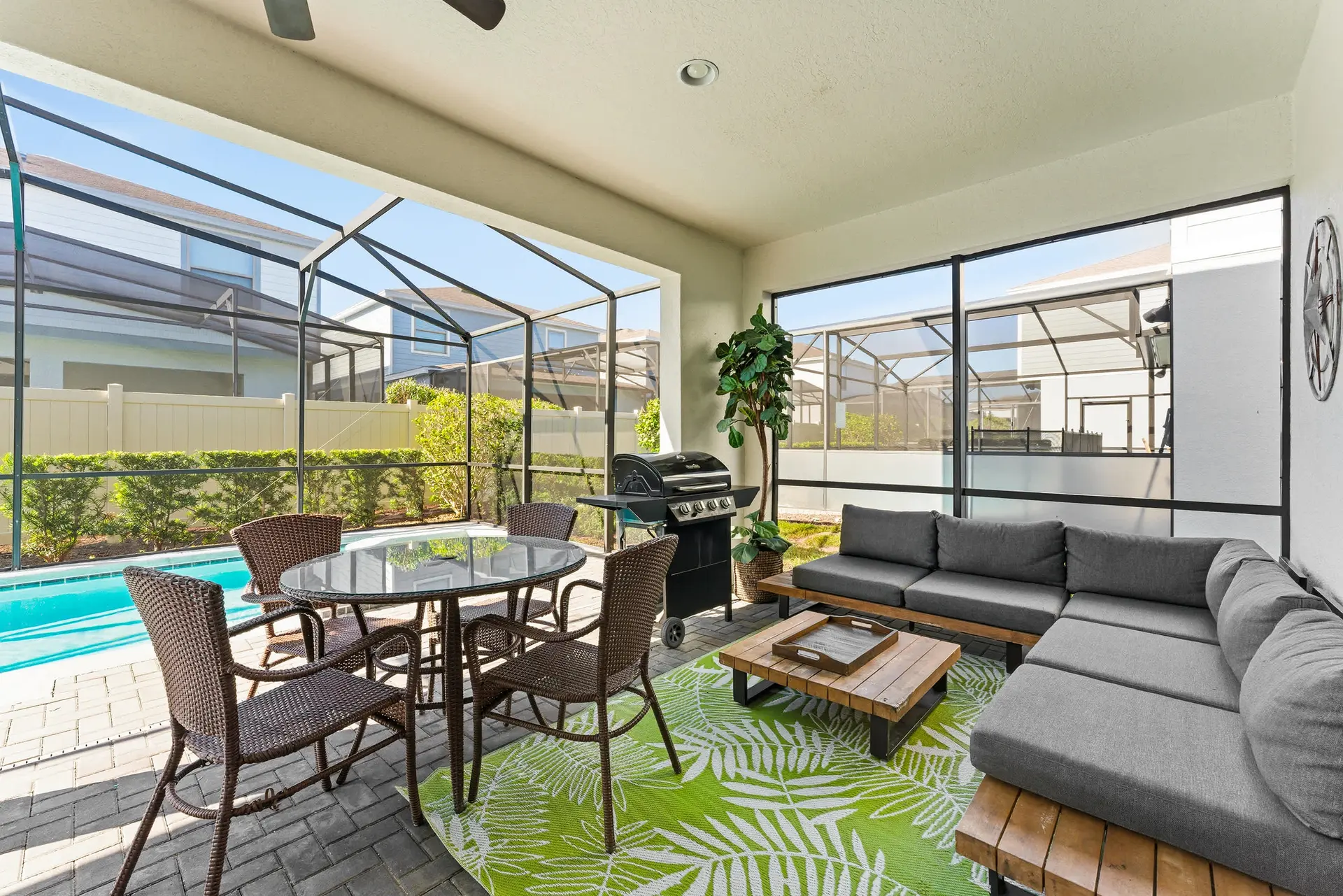 An outdoor patio with a grill, dining set, and sectional sofa.