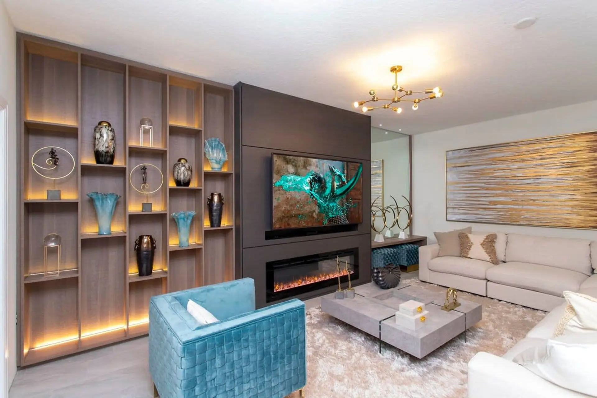 A modern living room with a fireplace, TV, and a large sectional sofa.