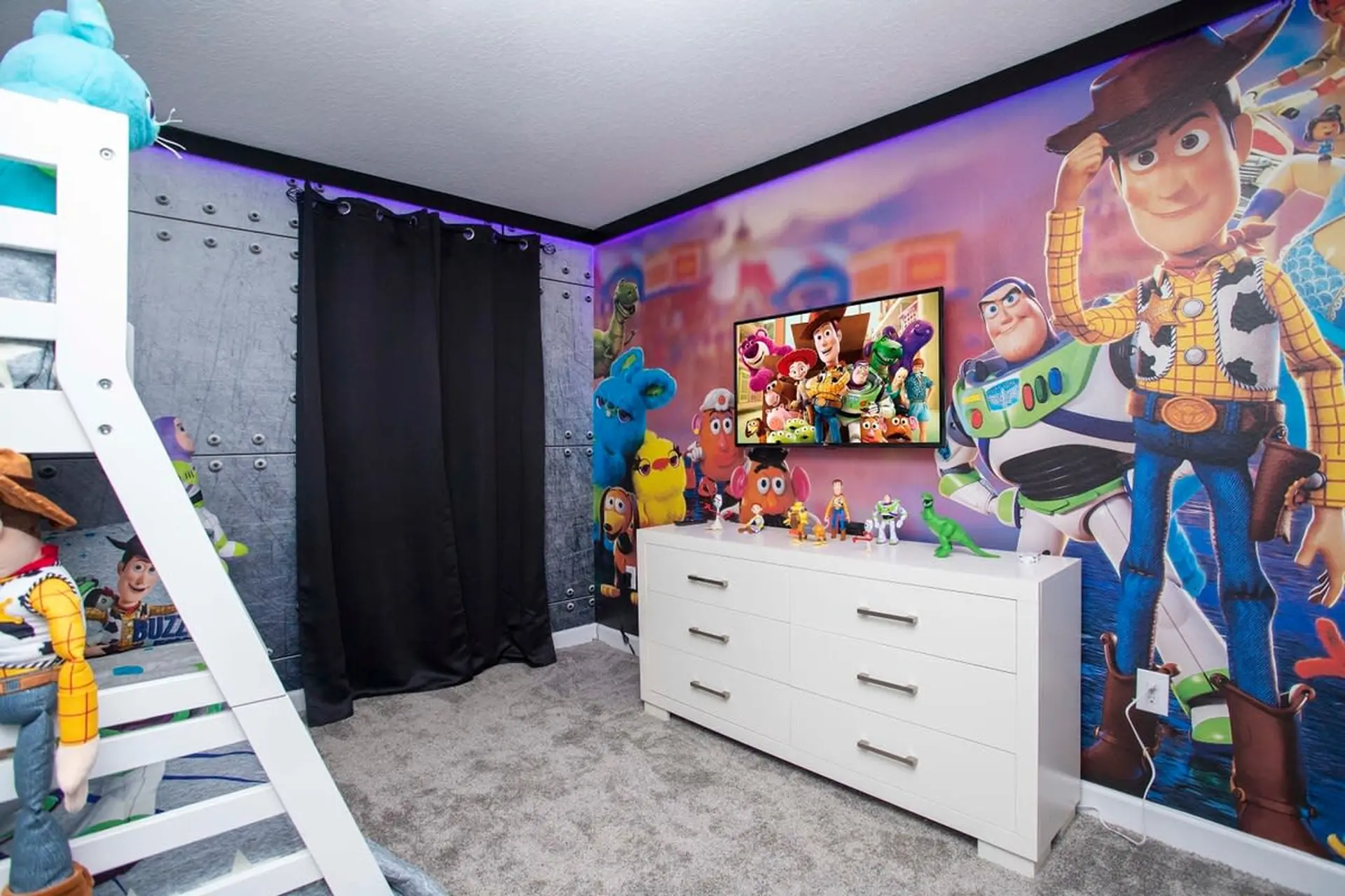 A child's bedroom featuring Toy Story characters, a bunk bed, and a dresser.