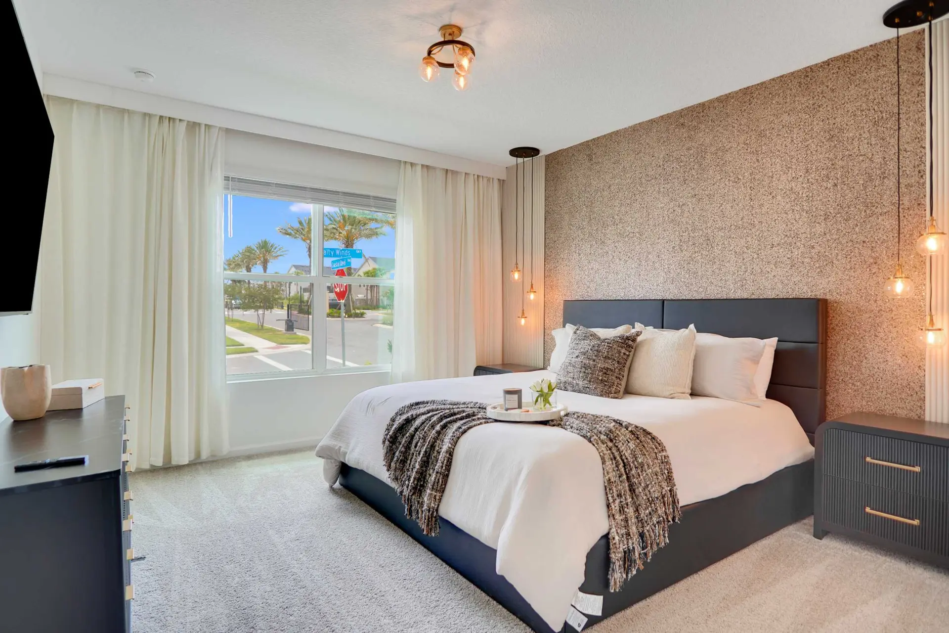 Bedroom with a bed, nightstand, dresser, and a window view.