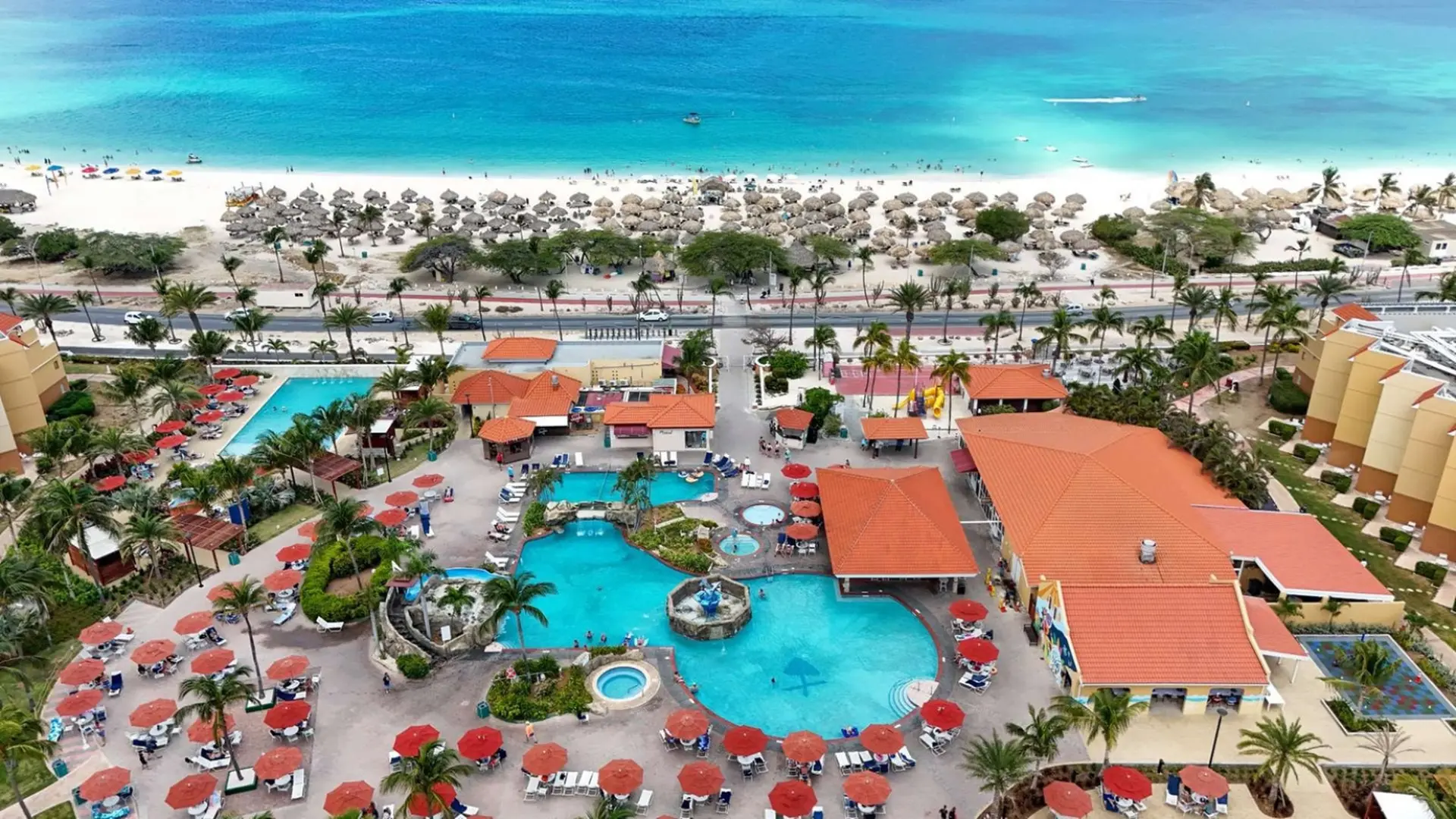 Resort with pools and beach access on a tropical island.