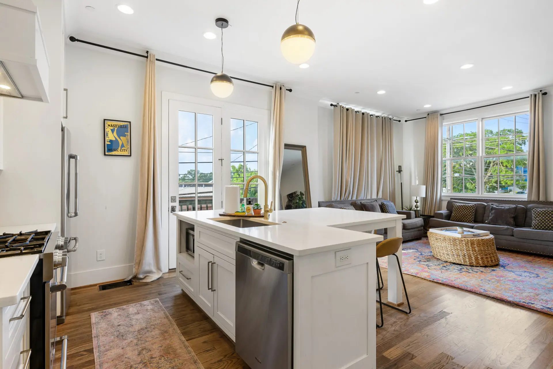 A bright open-concept kitchen and living room with a large island.