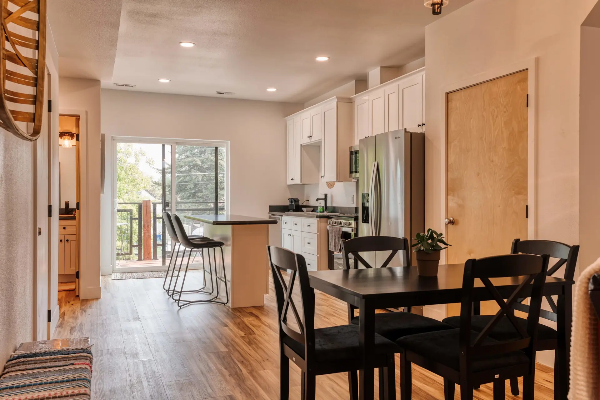 A modern kitchen with dark wood furniture and stainless steel appliances.