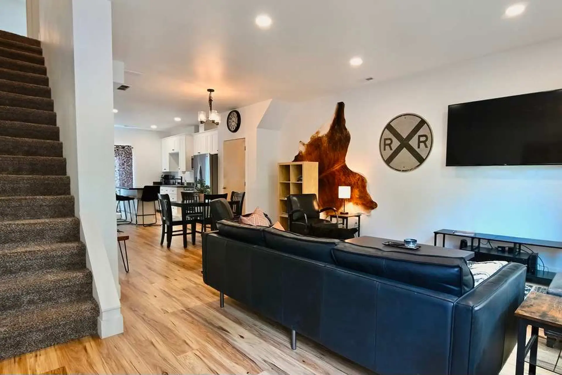Living room and kitchen area with dining table, couch, and TV.